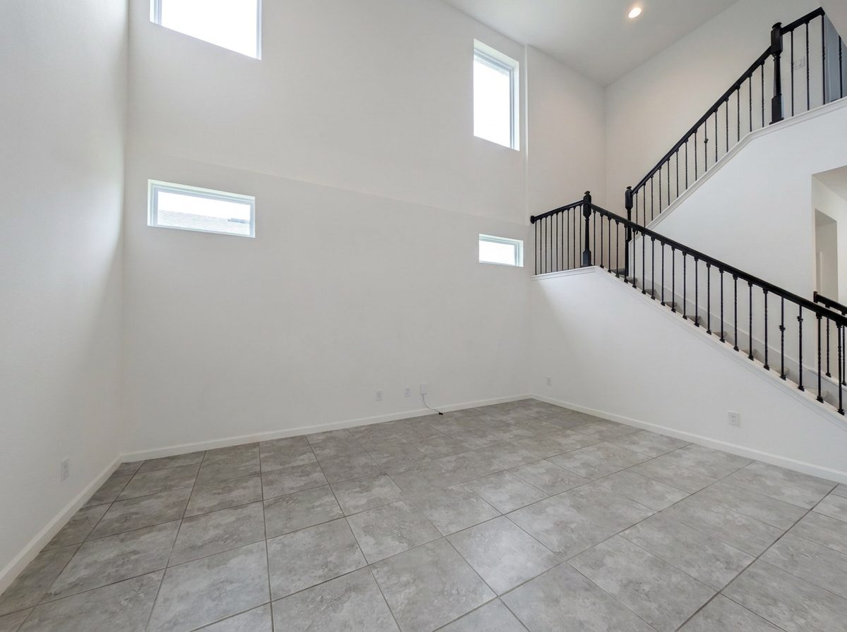 Two-story great room with a wall of windows and black-railed staircase at 2275 Abilia Aly, Apopka