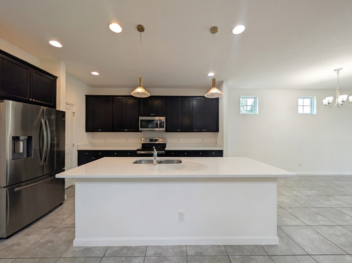 Kitchen with a stainless French-door refrigerator and center island at 2275 Abilia Aly, Apopka